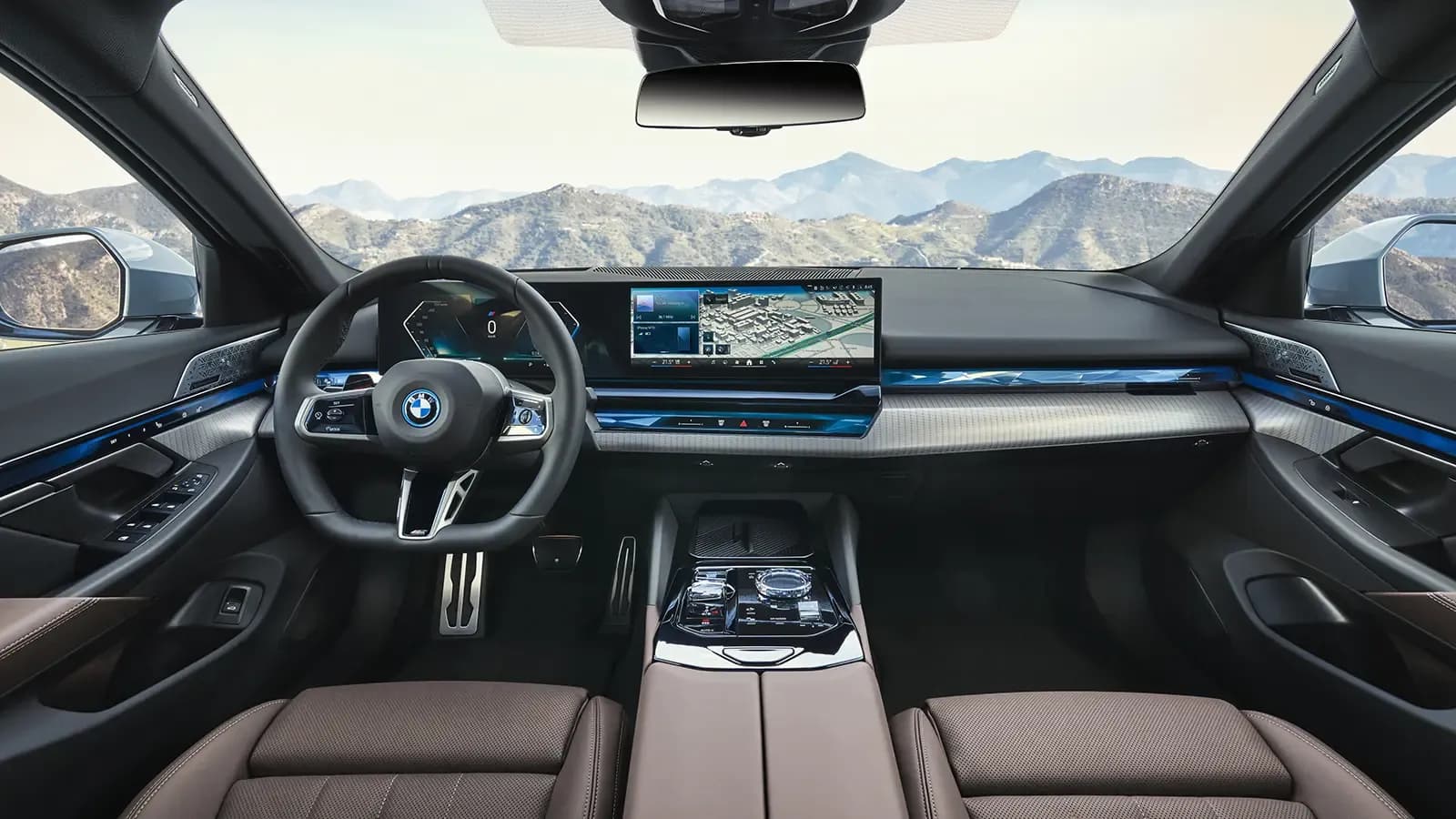 A view of the BMW i5 EV interior dash over the mountains