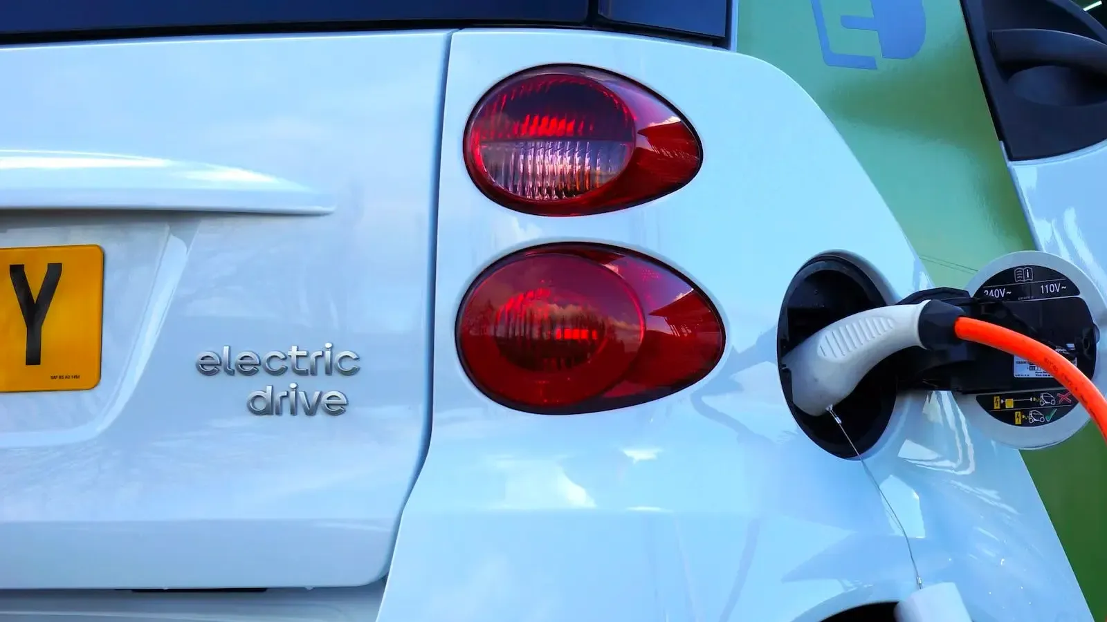 zoom in of electric car charging