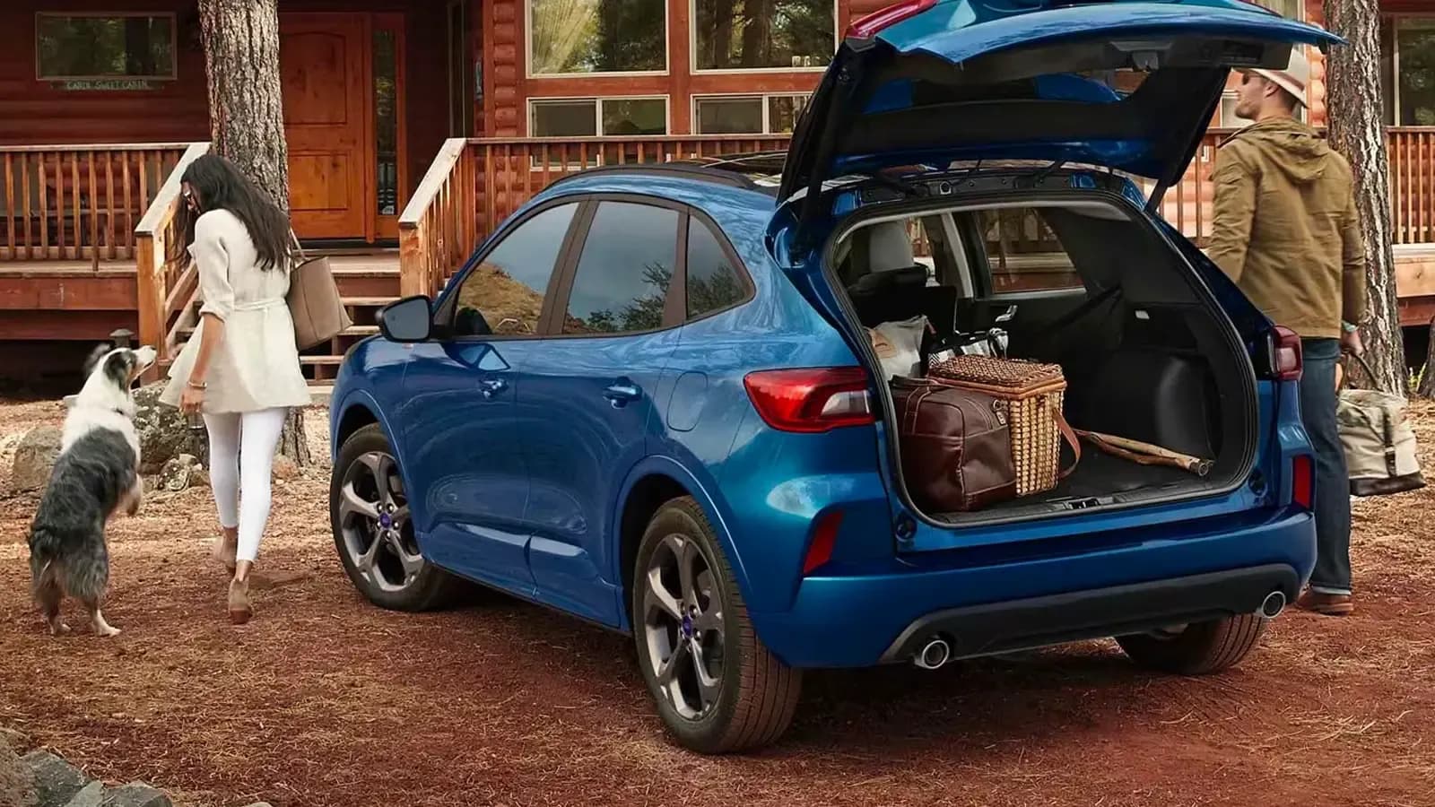 Ford Escape PHEV blue trunk view by a home and family