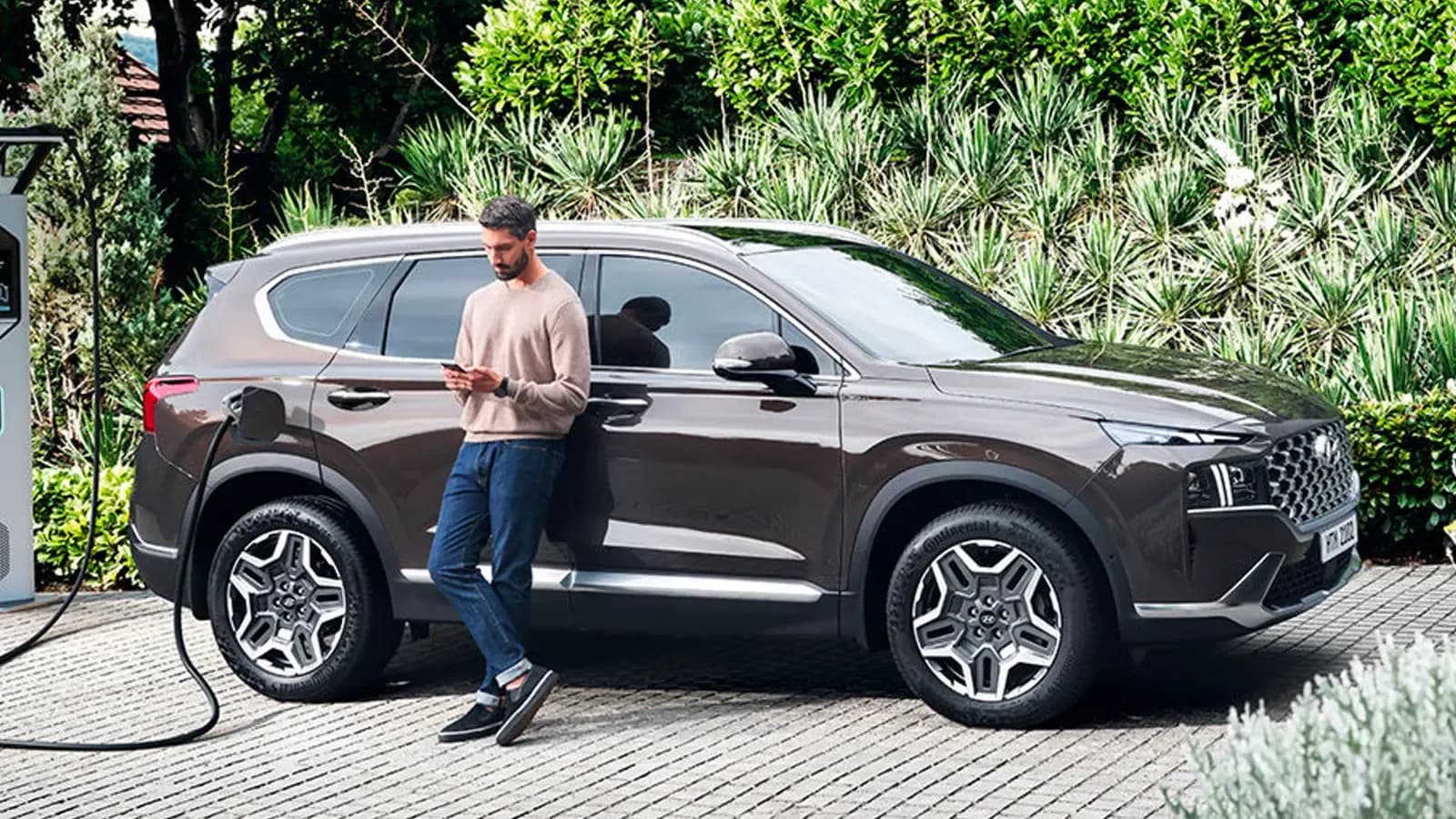 Man charging his Hyundai Santa Fe PHEV
