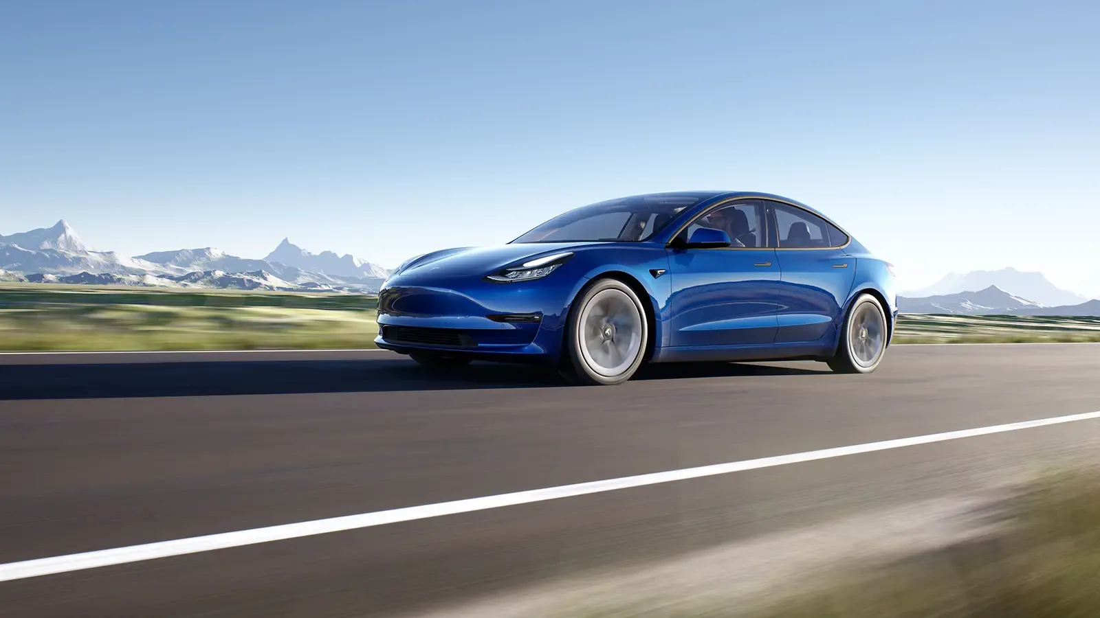 Blue Tesla Model 3 driving on the road