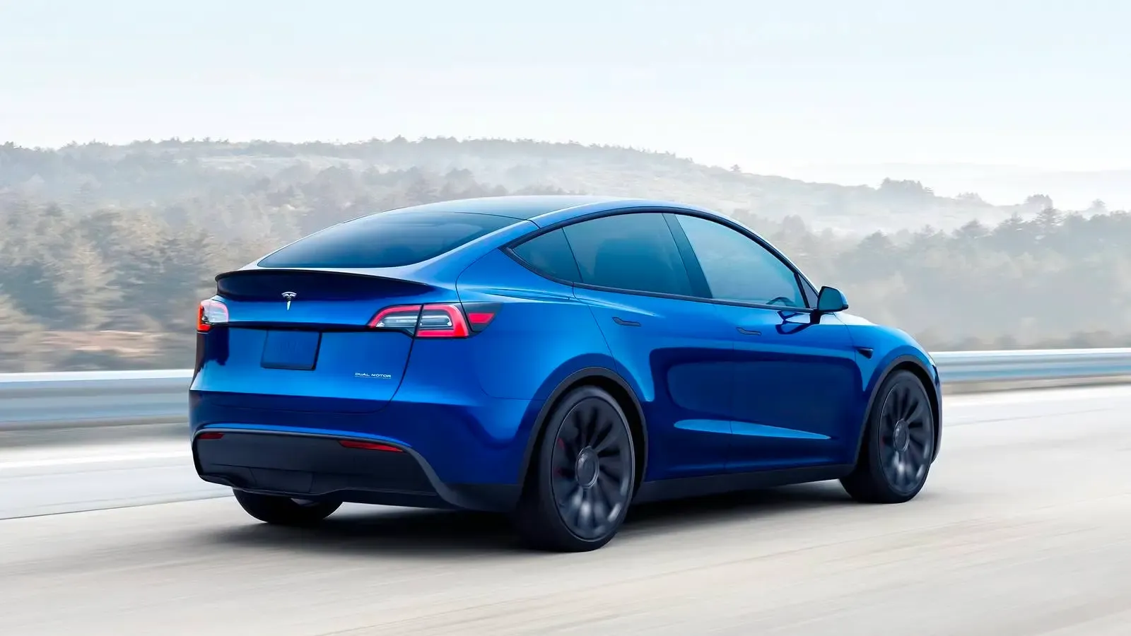 Tesla Model Y Performance in blue driving on the road