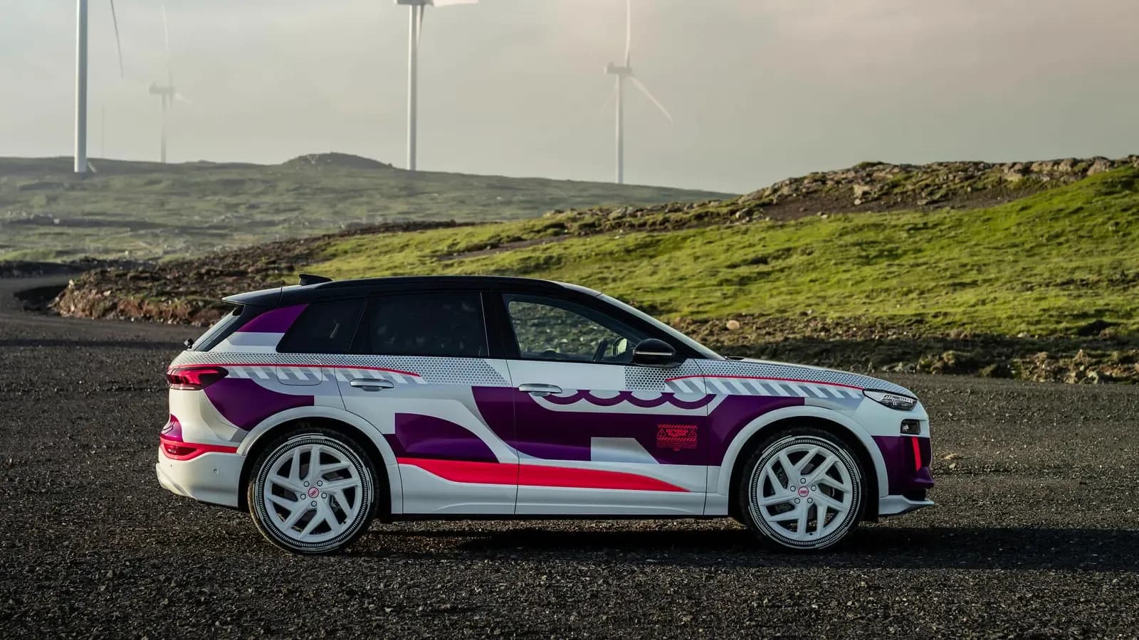 Pictured is the side profile of the Q6 e-tron prototype, parked by the sea.