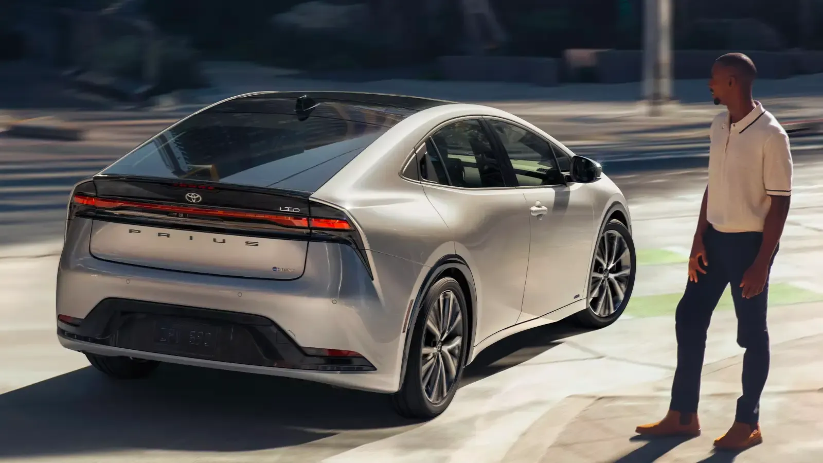 2023 Toyota Prius Hybrid parked by a man on the road