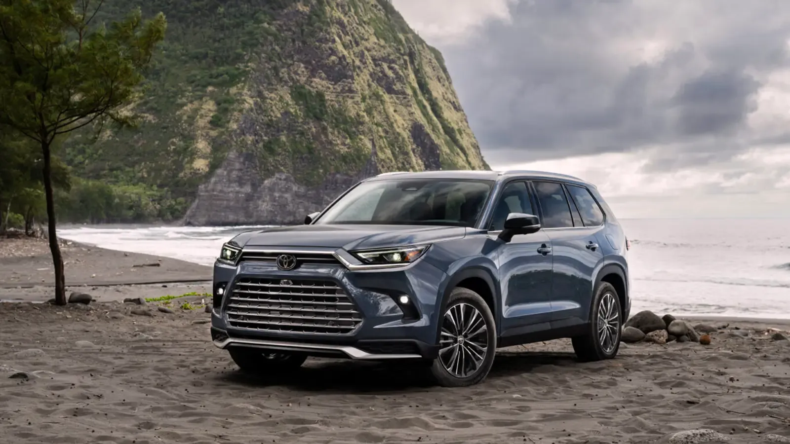 2024 Toyota Grand Highlander parked by a beach, front exterior view