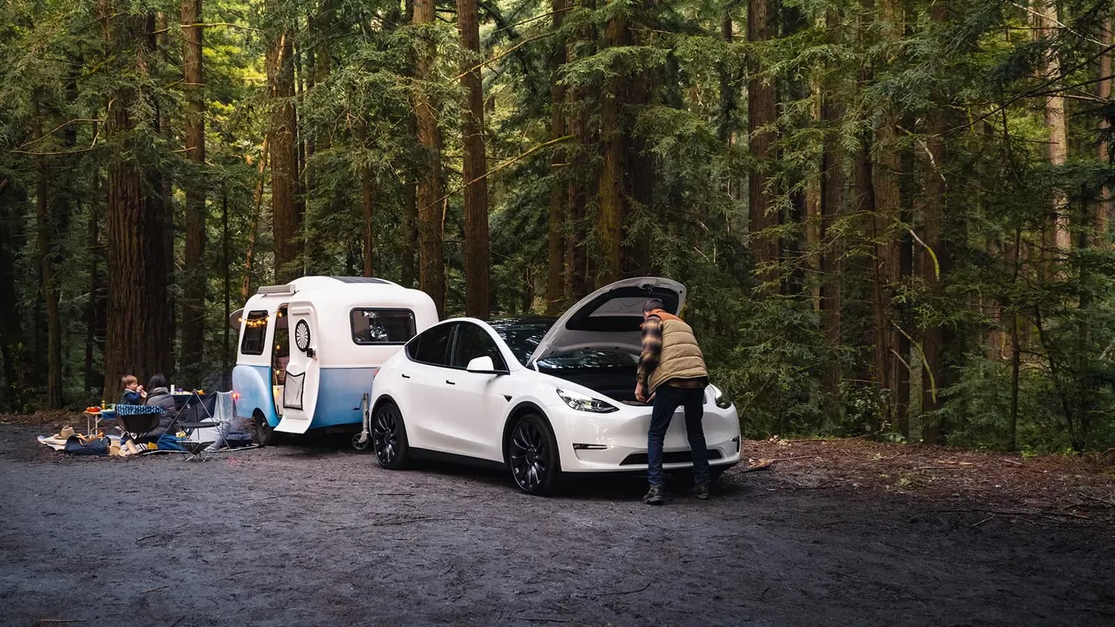 Tesla Model Y in a camping forest setting