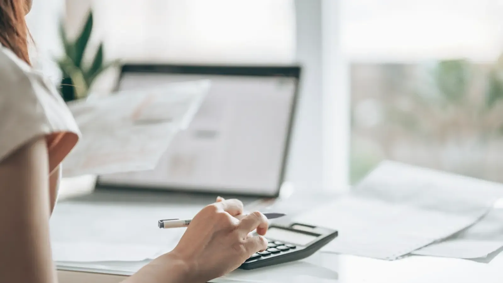 Close of up of a woman calculating her taxes