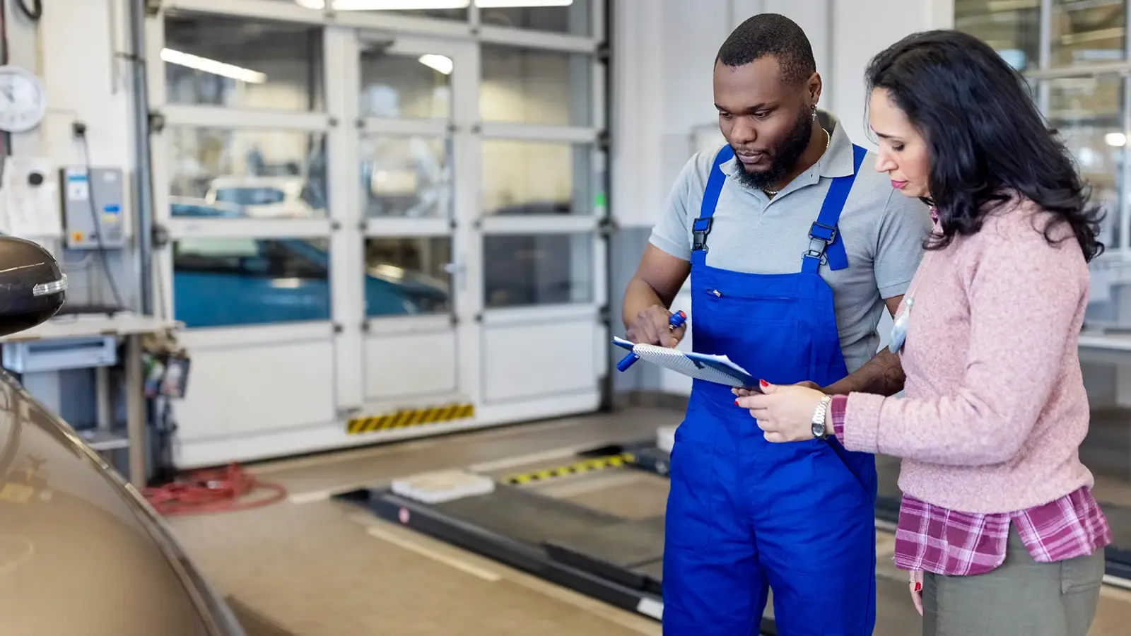 Technician looking over paperwork with a customer