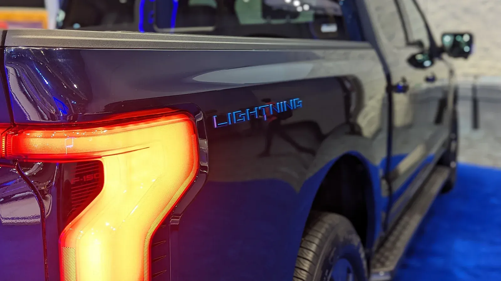 A Ford Lightning electric truck parked at a showroom