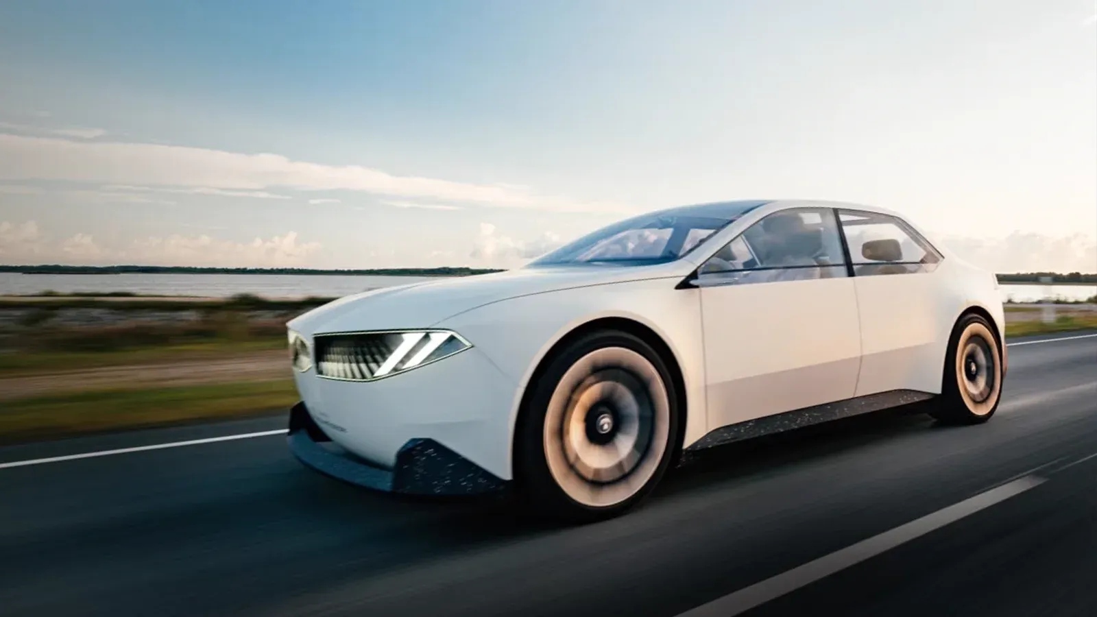 close up shot of a bmw 3-series ev driving down an empty road