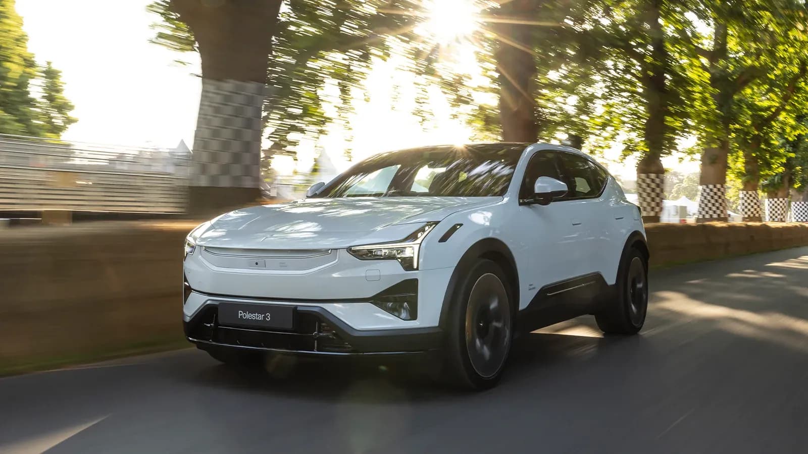 Polestar 3 driving on tree-lined road