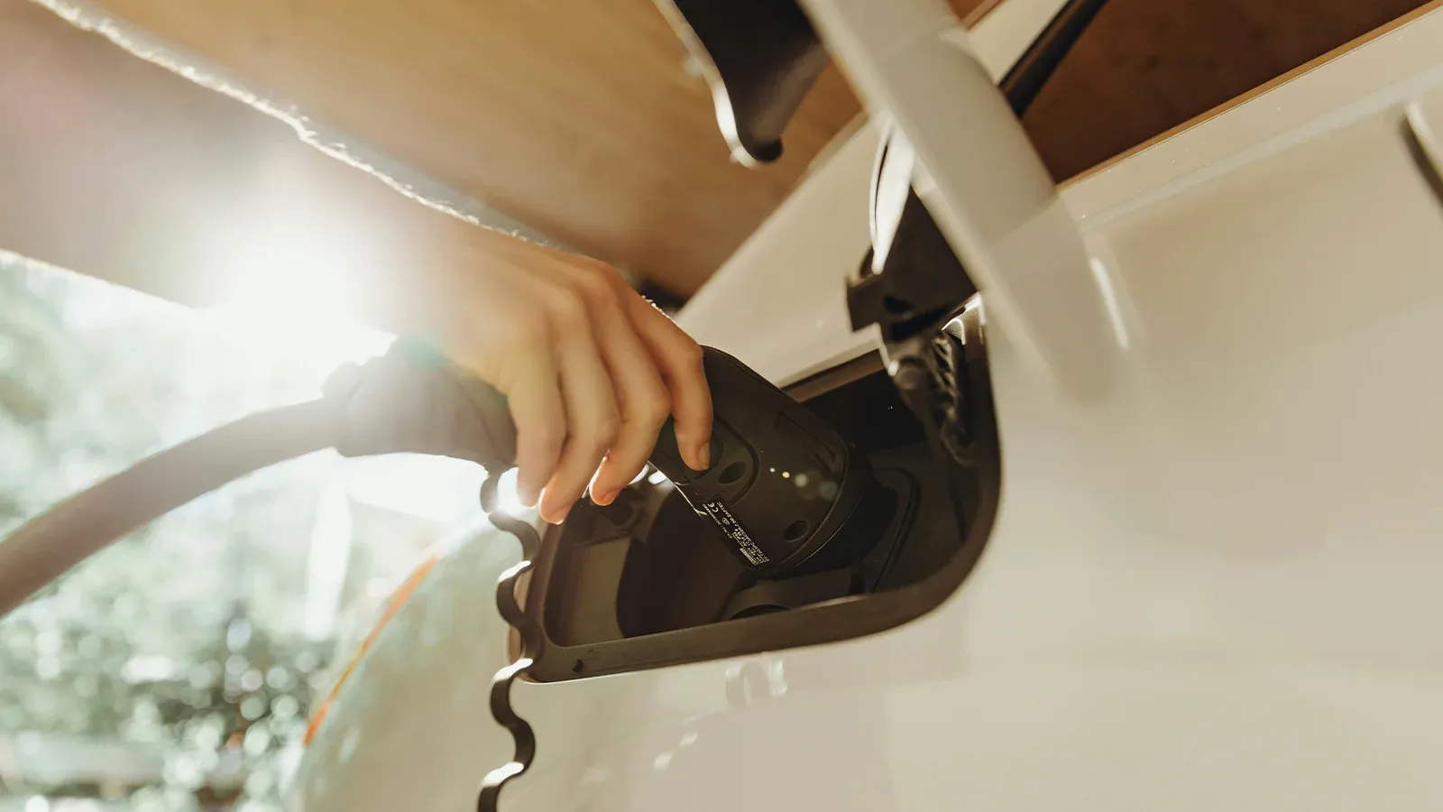 Someone plugging in their EV to charge