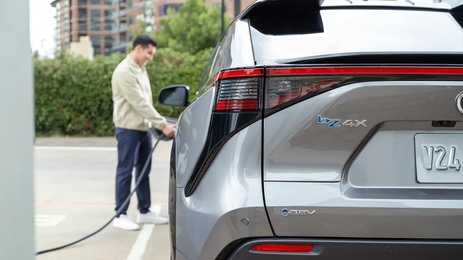 person charging electric vehicle