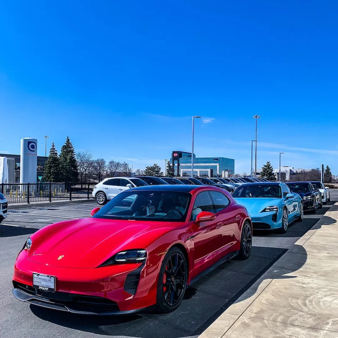 4 Porsche Taycan electric cars parked outside Humber College