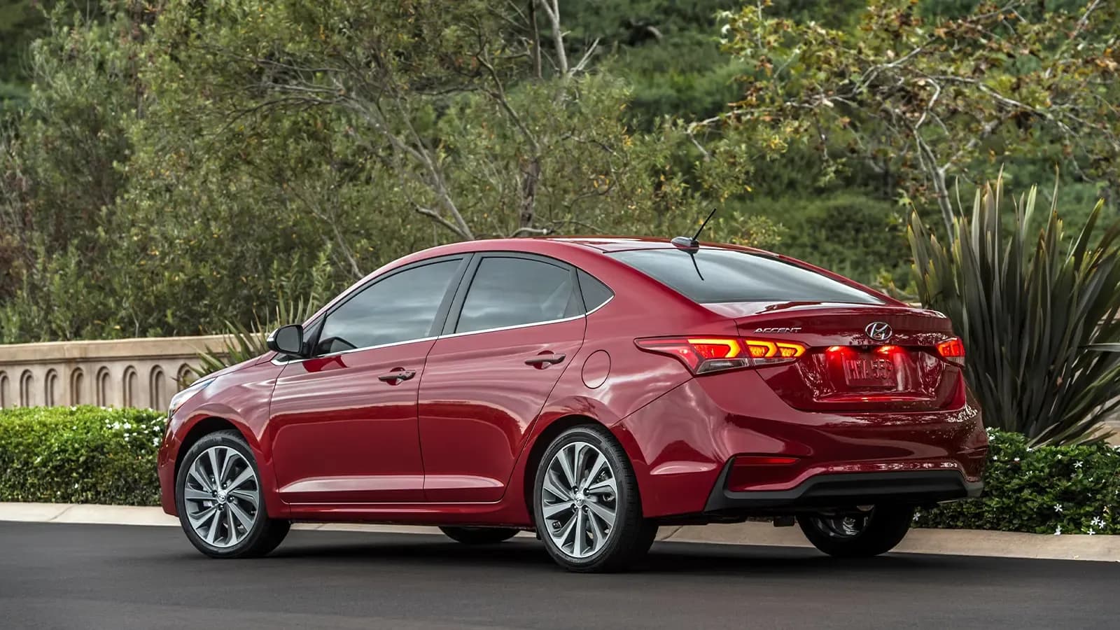Hyundai Accent parked near tree