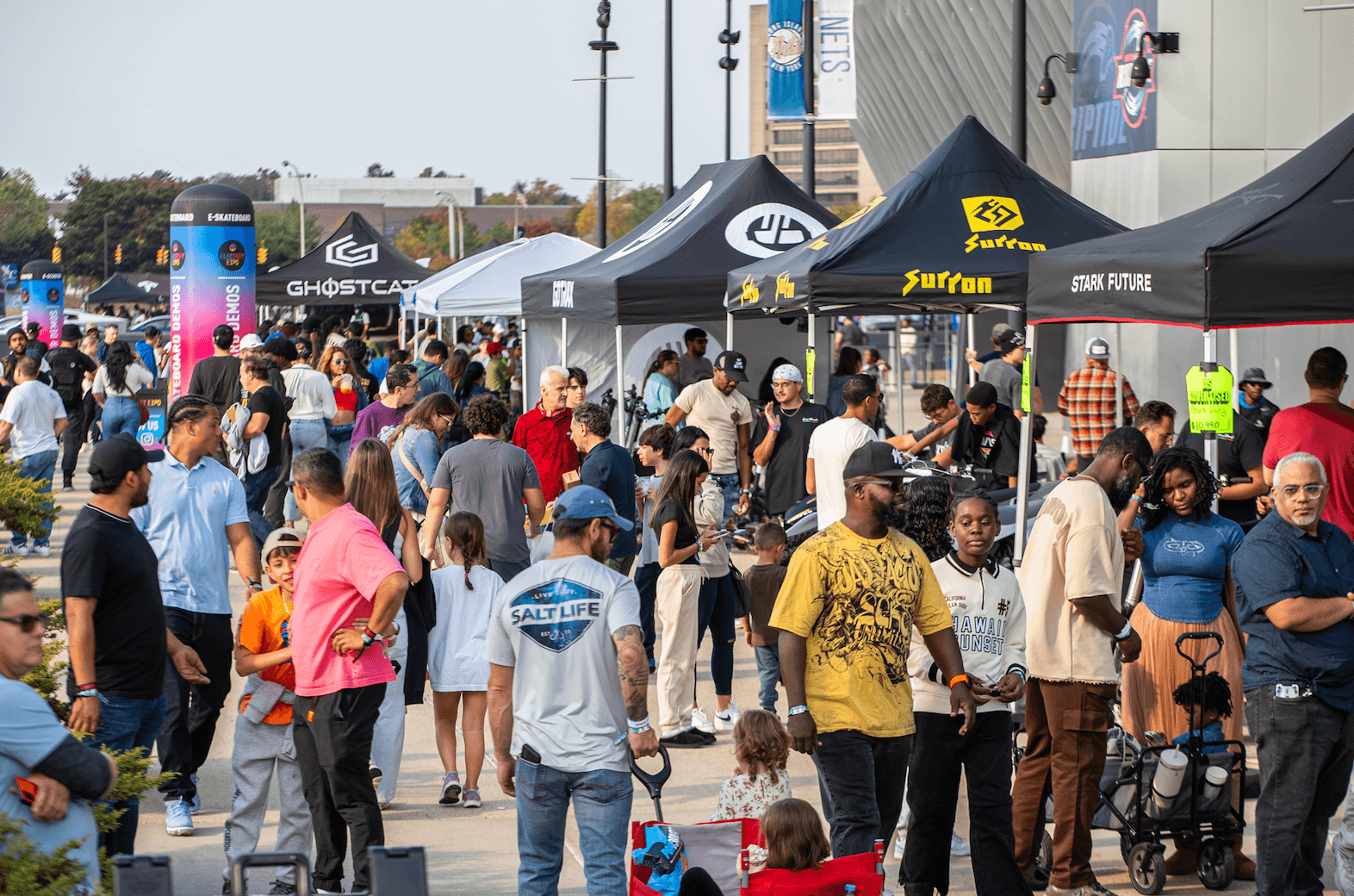 Una multitud camina entre carpas de vendedores en Electrify Expo New York.