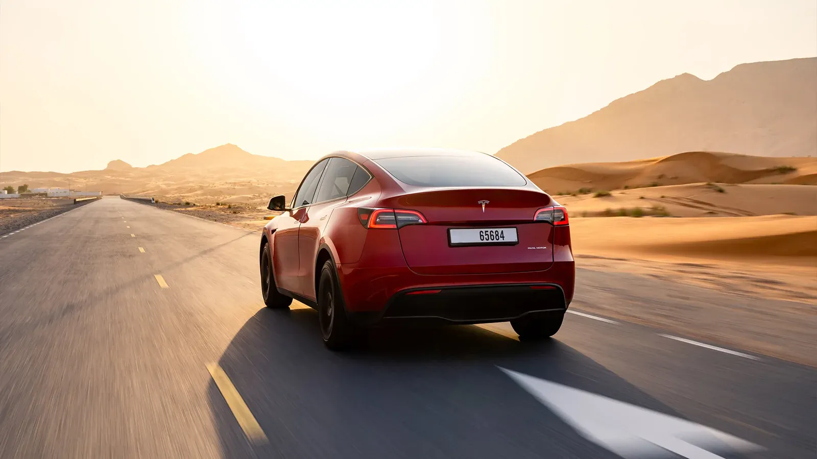 red EV driving on a highway
