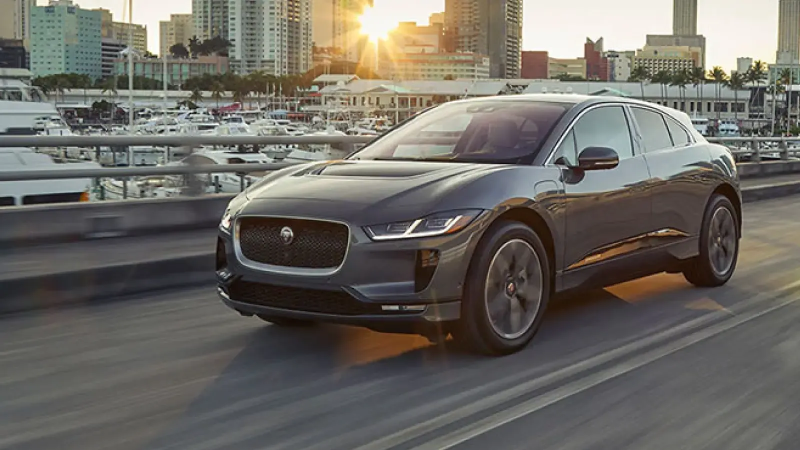 2021 Jaguar I-Pace driving along harbor and city
