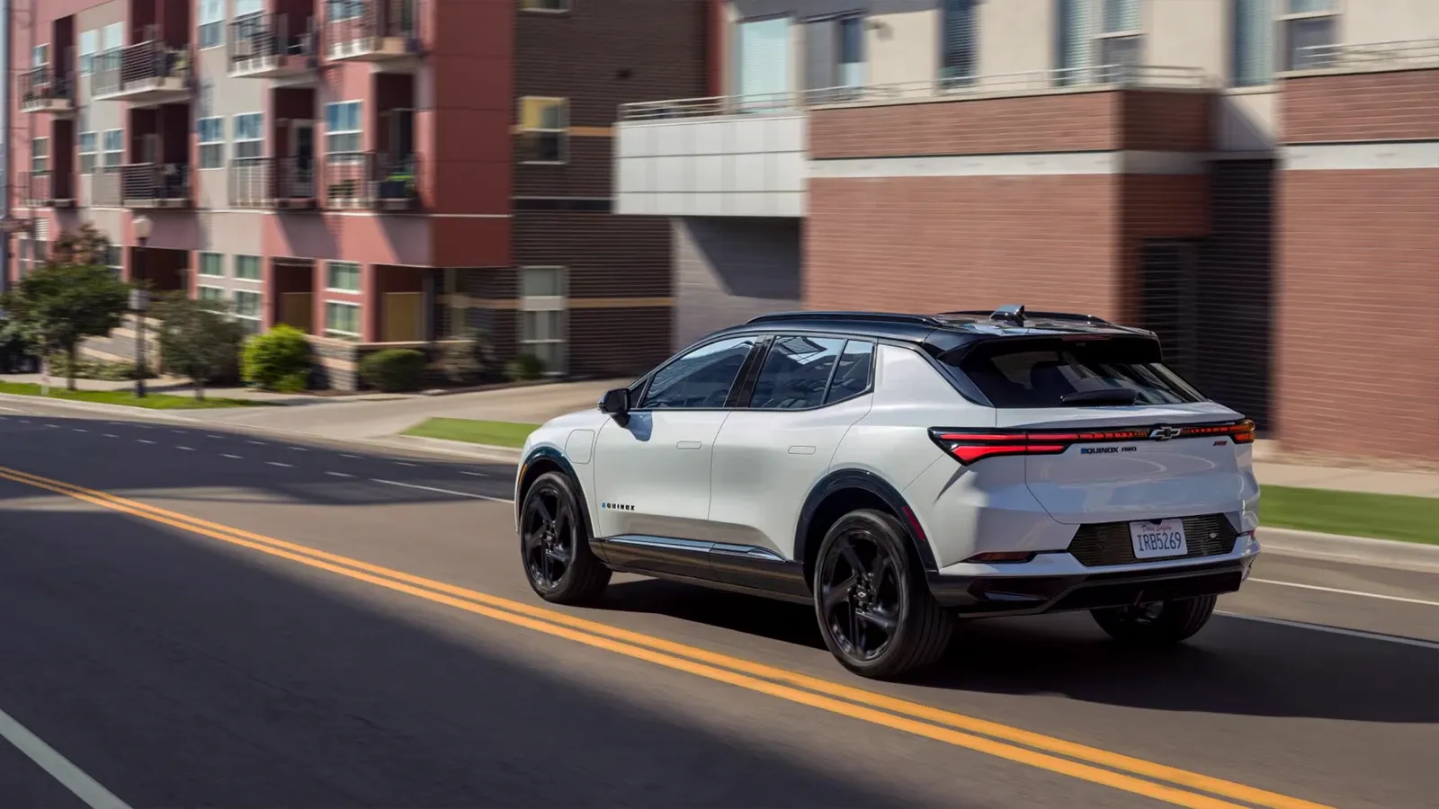 white Chevy Equinox EV driving on the road