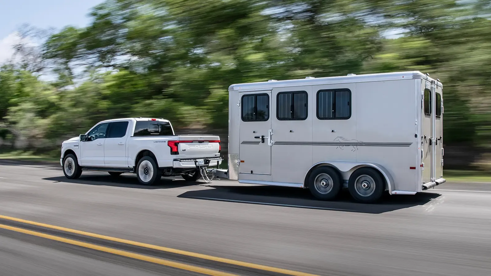 white ford f-150 towing on the road
