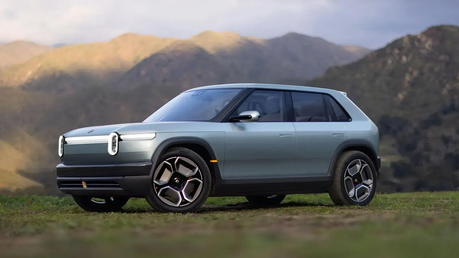 Rivian parked on top of a mountain