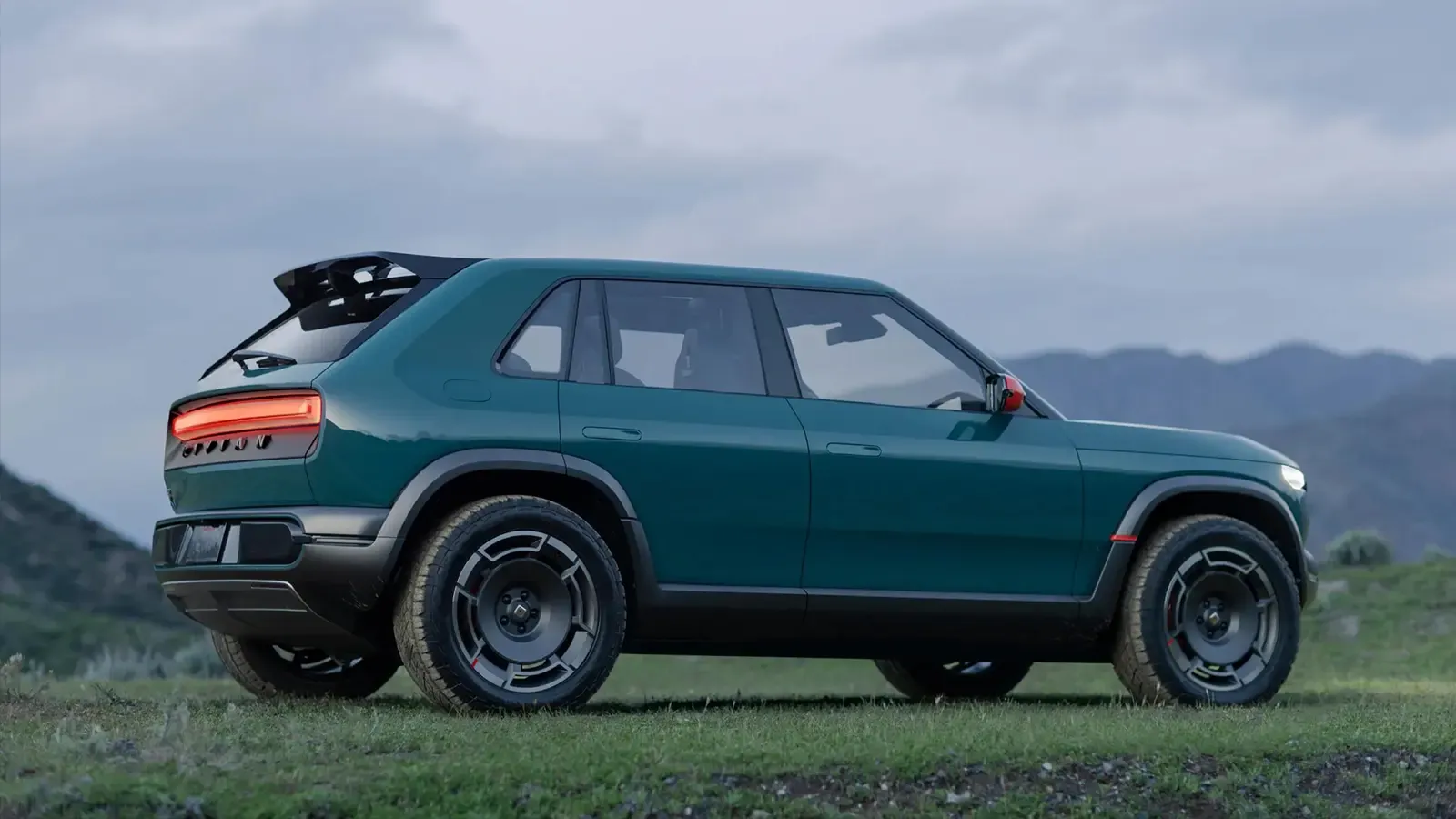 rivian parked on top of a mountain
