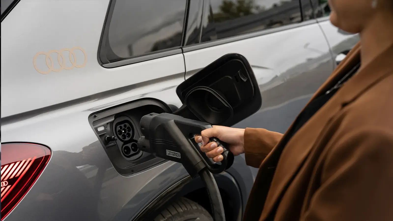 Woman plugging in an 2023 Audi Q4 e-tron