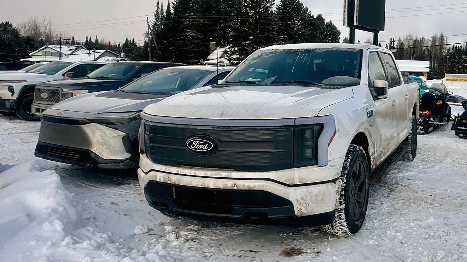 white Ford F-150 Lightning in the snow