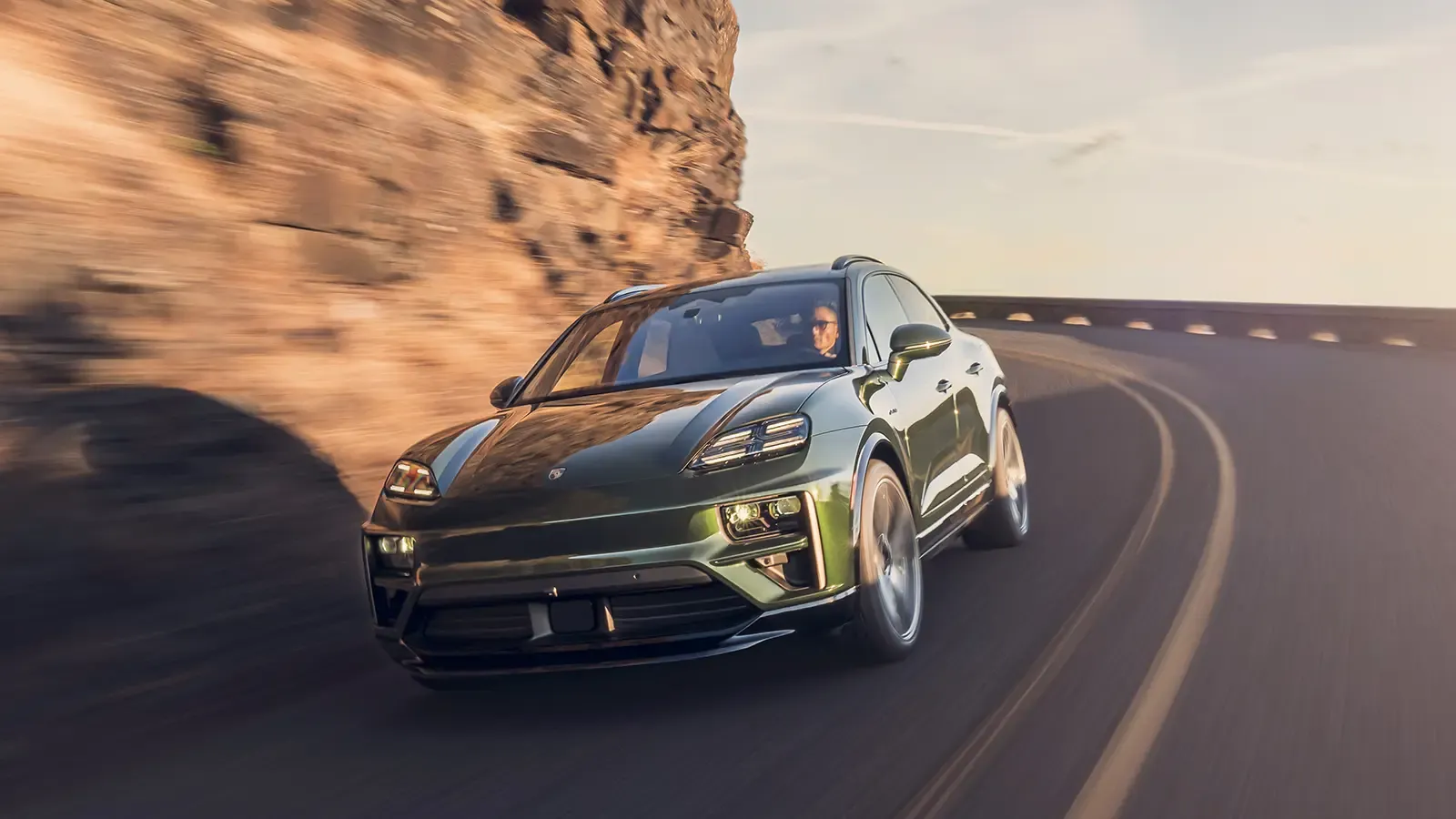 green Porsche Macan EV on the highway