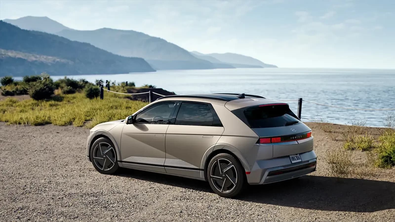 Rear three-quarter view of a Hyundai Ioniq 5 parked by the coast.
