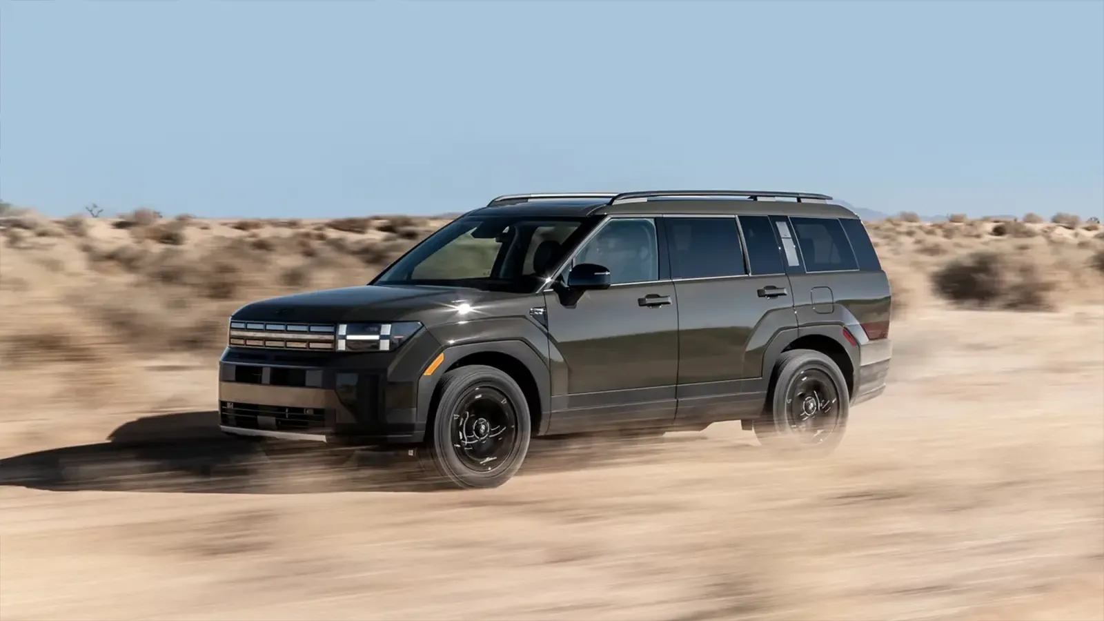 Dark colored 2025 Hyundai Santa fe driving throught the desert