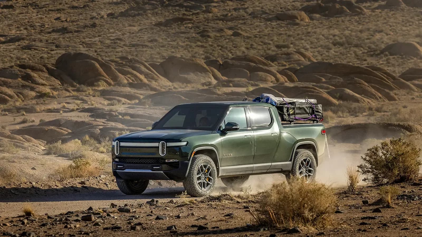 A Rivian R1 racing through the desert