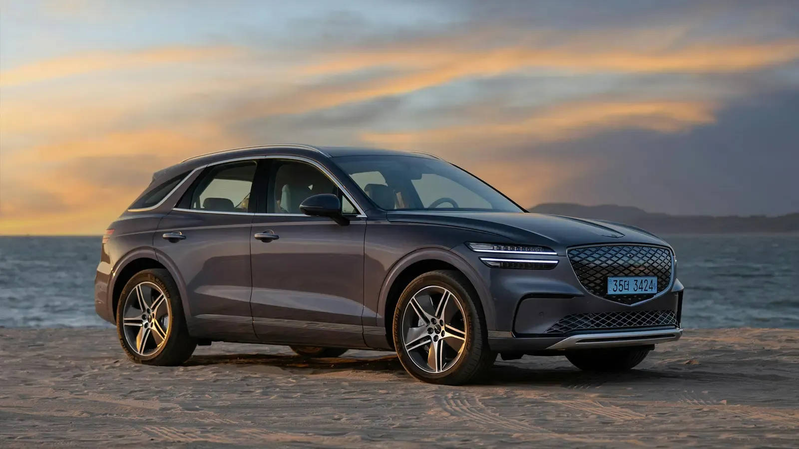 Hyundai EV on a beach at sunset