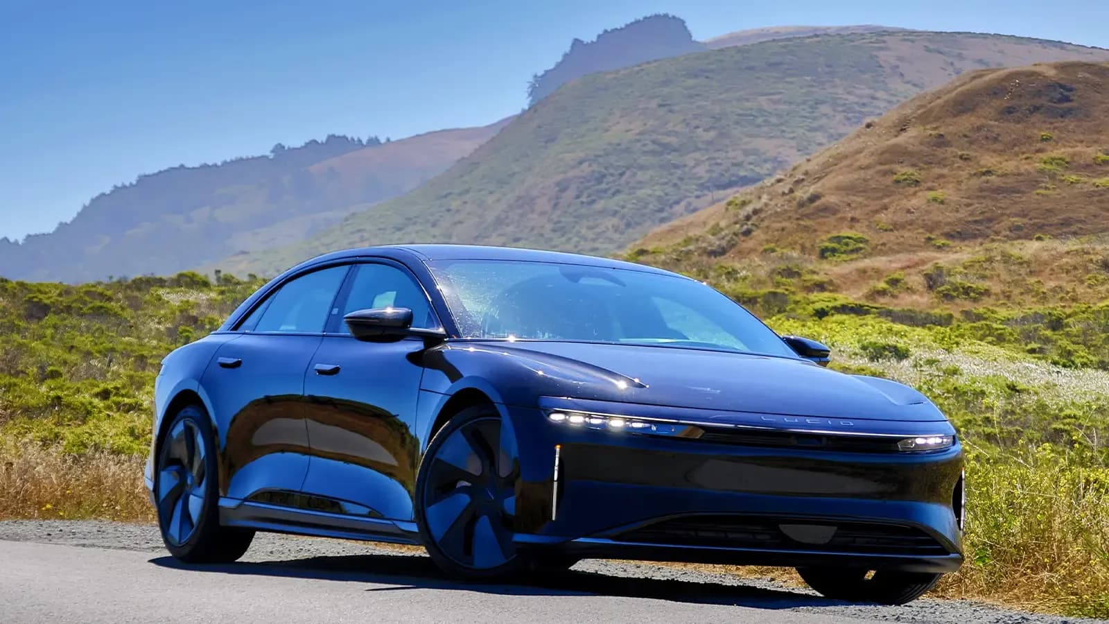 A Black 2025 Lucid Air Grand Touring in a beautiful scenic background