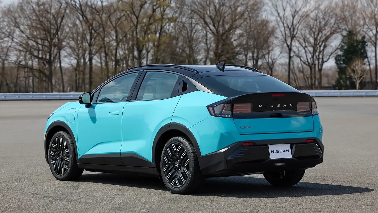 A light blue 2026 Nissan Leaf rear view