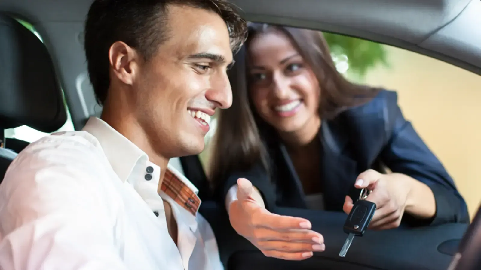 Man buying car from woman