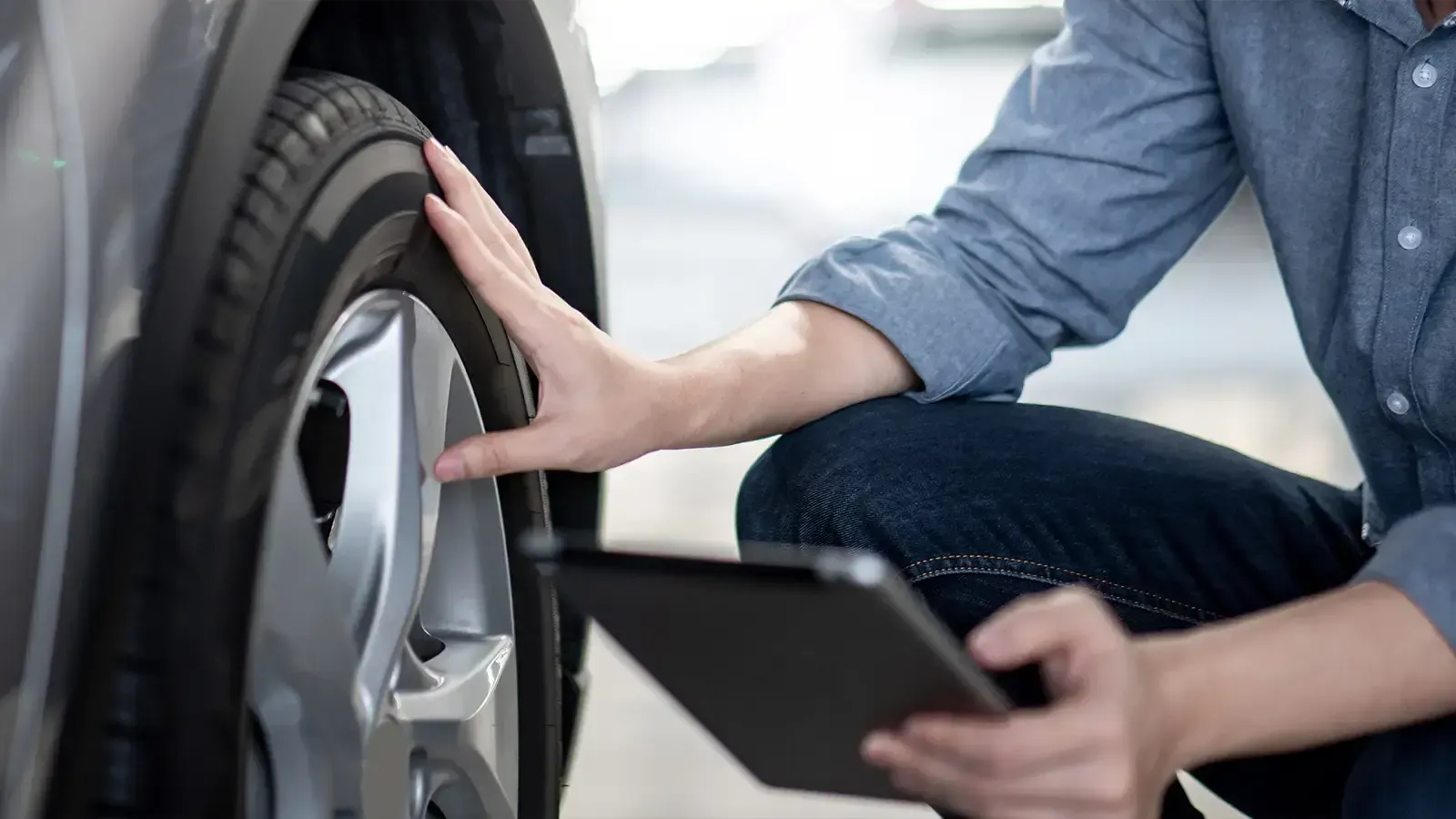 Man checking tires of an electric vehicle