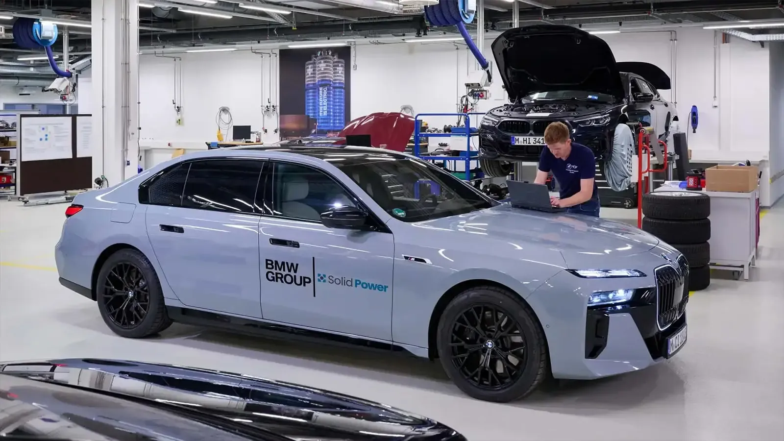 A light blue BMW i7 solid state battery prototype in the shop