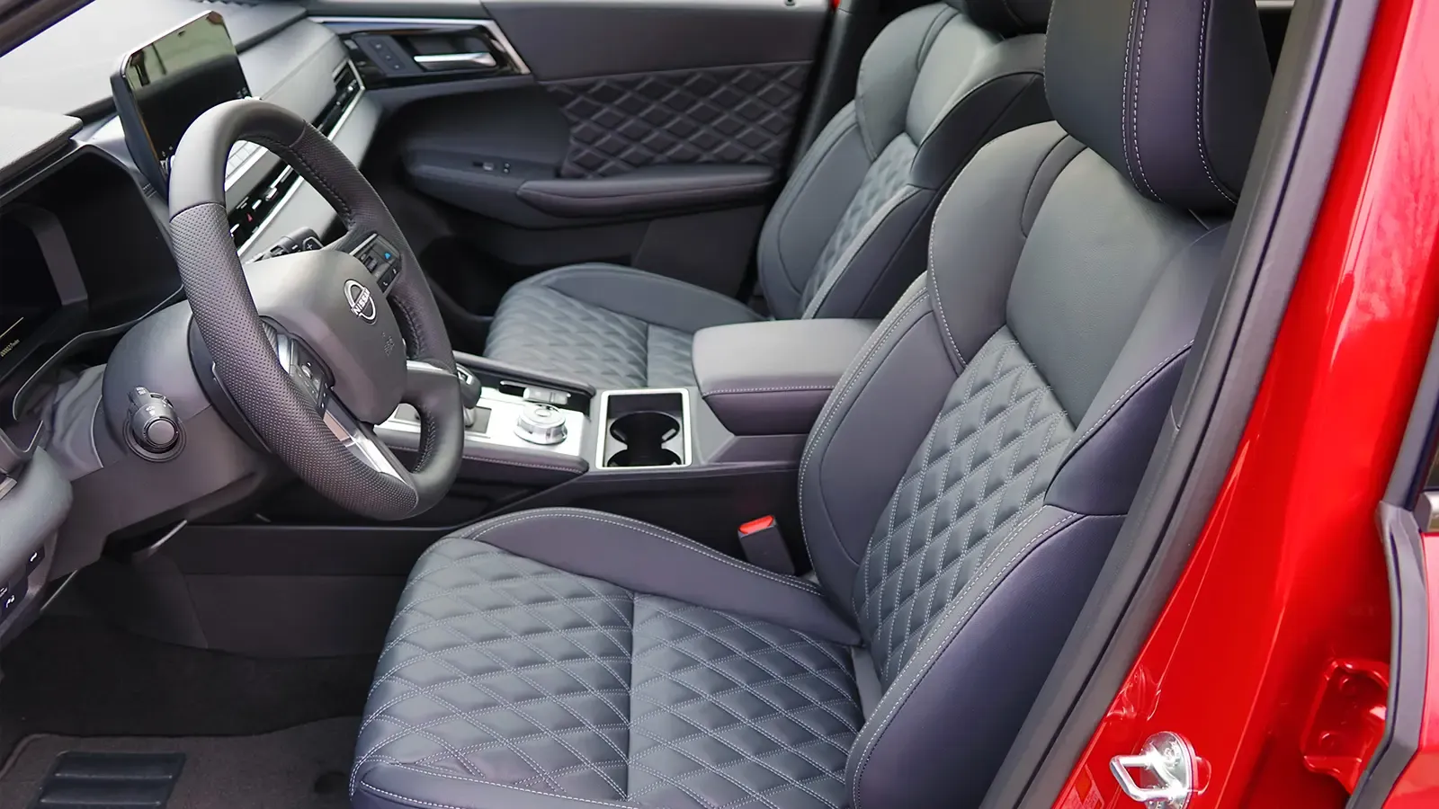 A red 2026 Nissan Rogue drivers side view