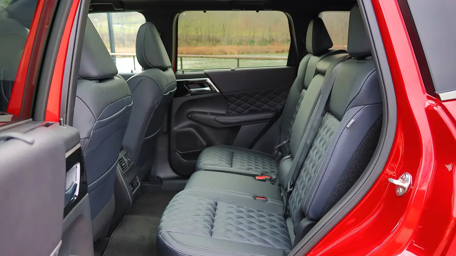 A red 2026 Nissan Rogue back seat view