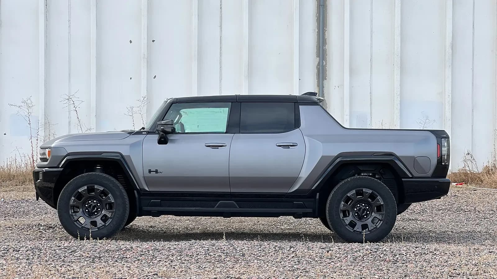 A dark gray 2026 GMC hummer EV pick up side view