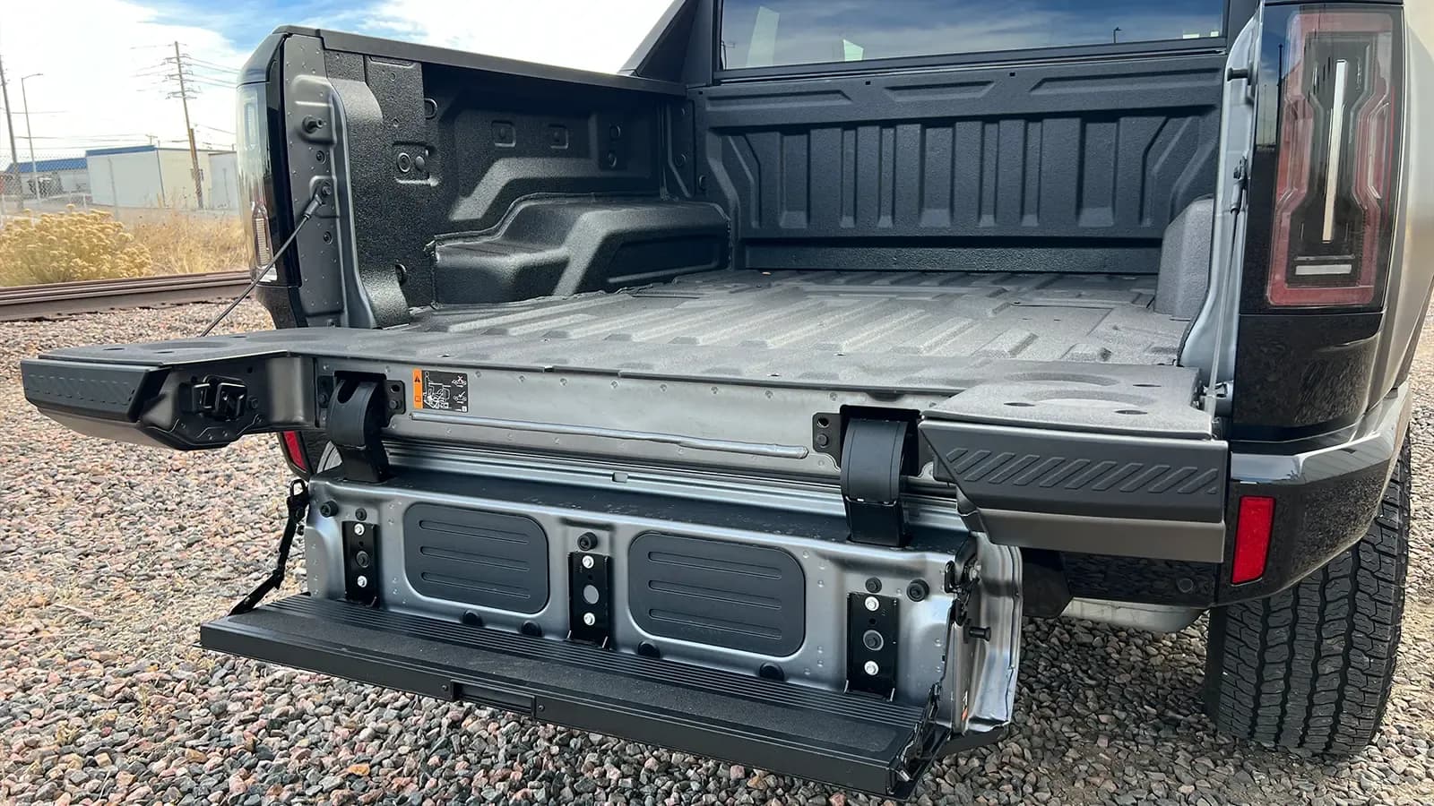 A dark gray 2026 GMC hummer EV pick up rear trunk lid