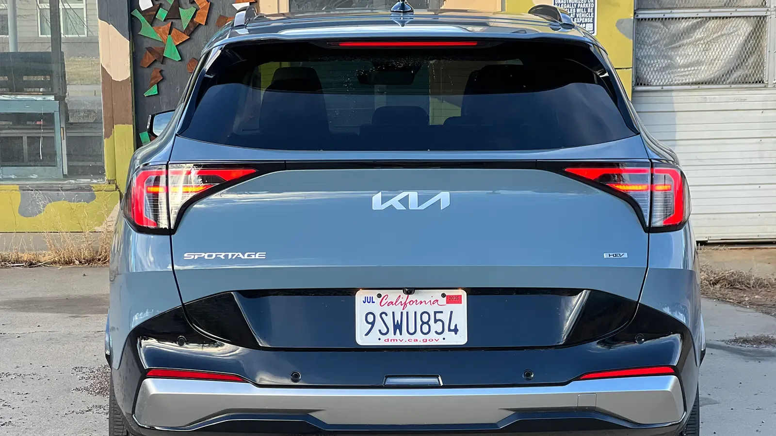 A dark blue 2026 Kia Sportage Hybrid SX Prestige rear view