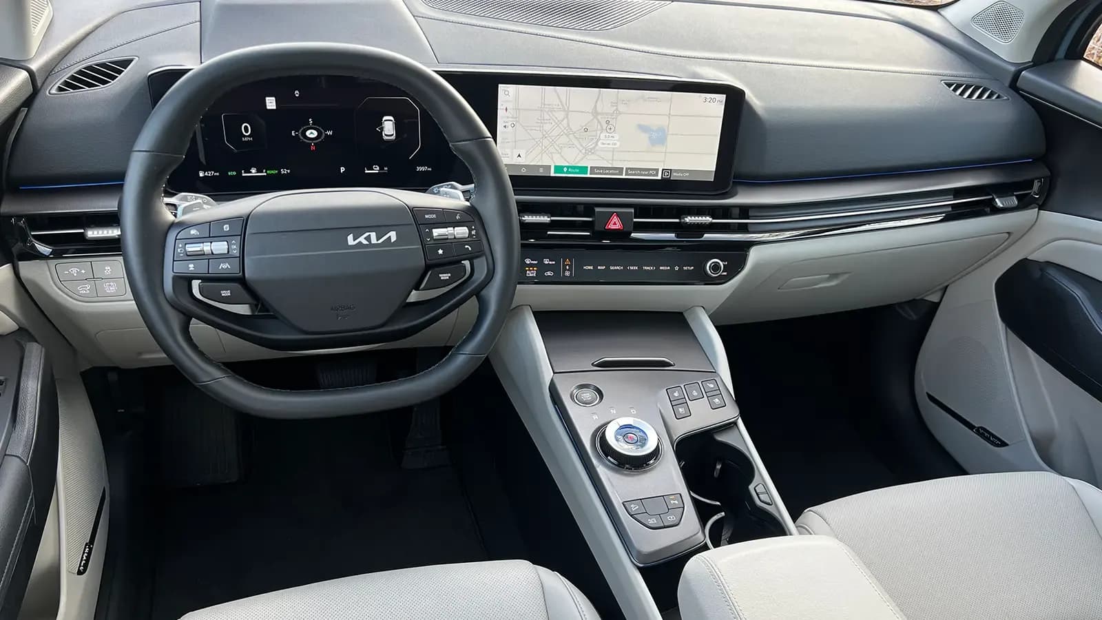 A dark blue 2026 Kia Sportage Hybrid SX Prestige driver front view interior