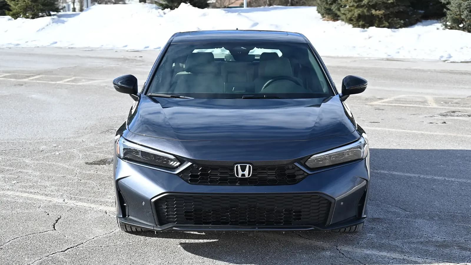 A dark blue 2026 Honda Civic Sport Touring Hybrid nose