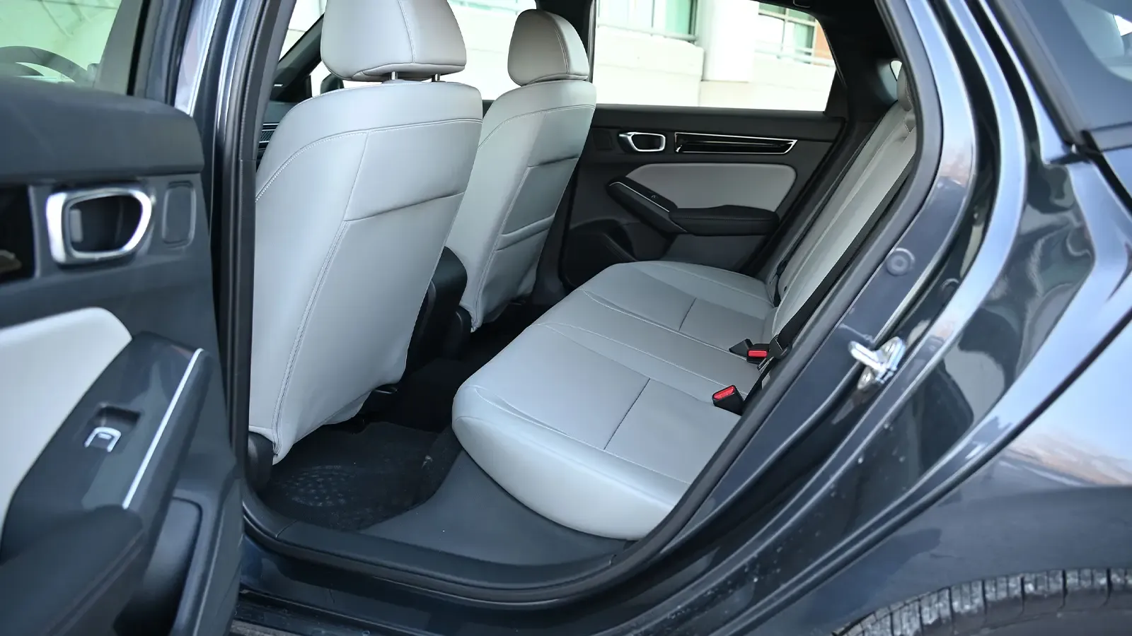 A dark blue 2026 Honda Civic Sport Touring Hybrid second row side view