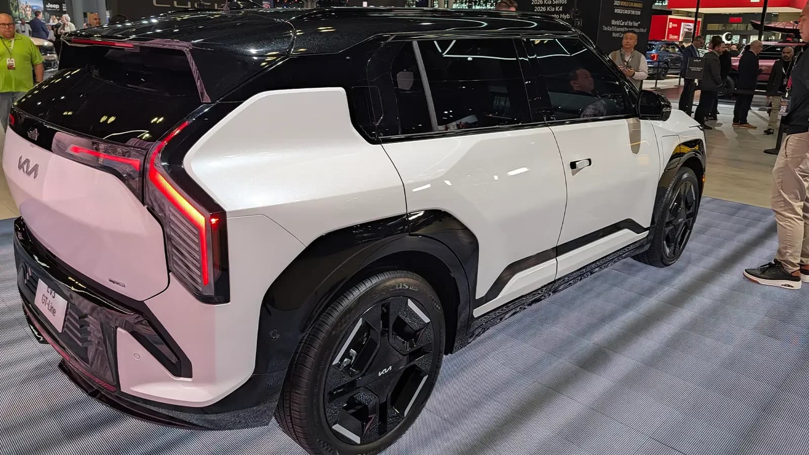 A white 2027 Kia EV3 three quarter rear view