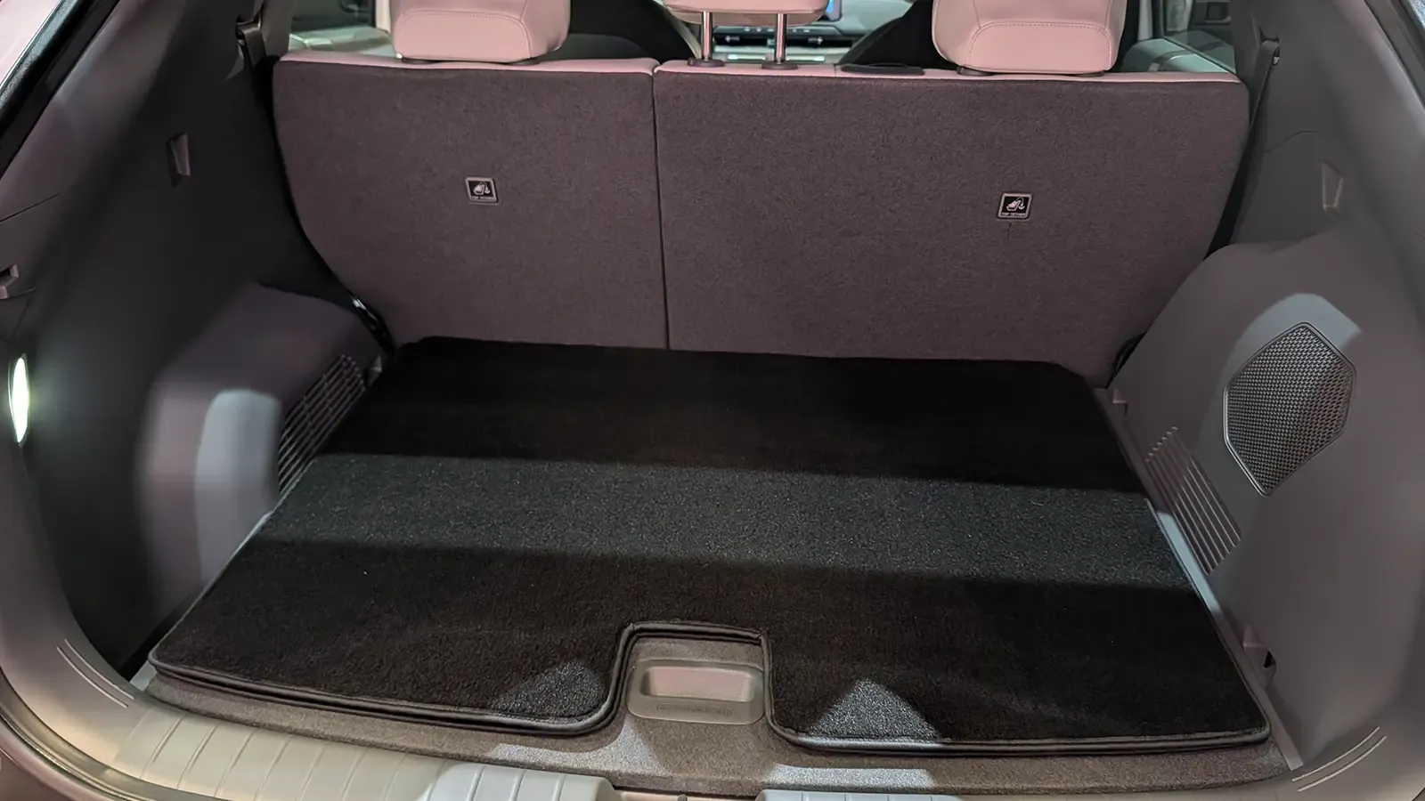 A white 2027 Kia EV3 rear trunk open view