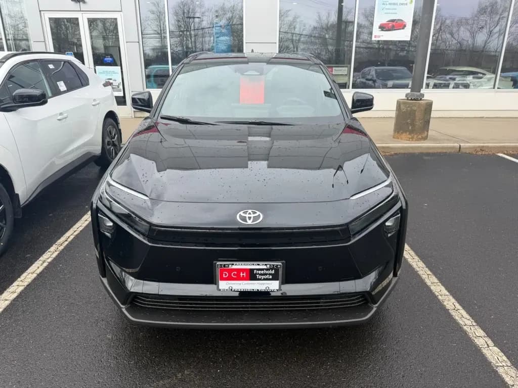 Front view of a Toyota bZ parked outside a dealership.