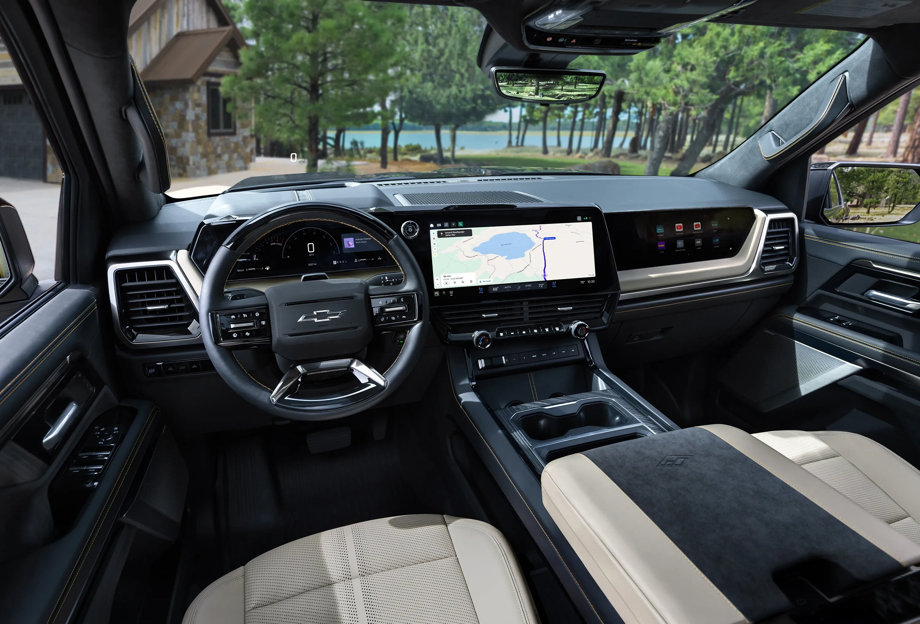 Driver's-seat view of a vehicle cockpit with a navigation map on the center screen.